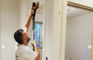 working the paint roller inside a home